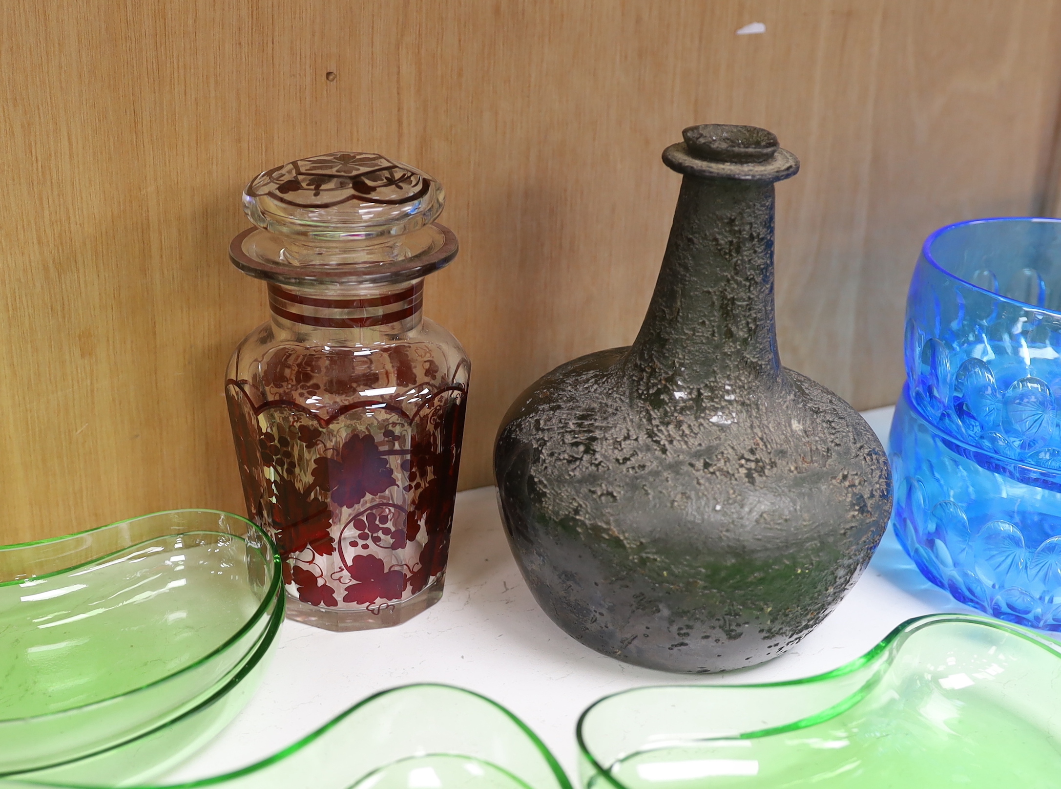 Assorted glassware including an 18th century Dutch onion shaped wine bottle, a set of six blue glass finger bowls and a Bohemian style decanter and stopper, largest 18cm high